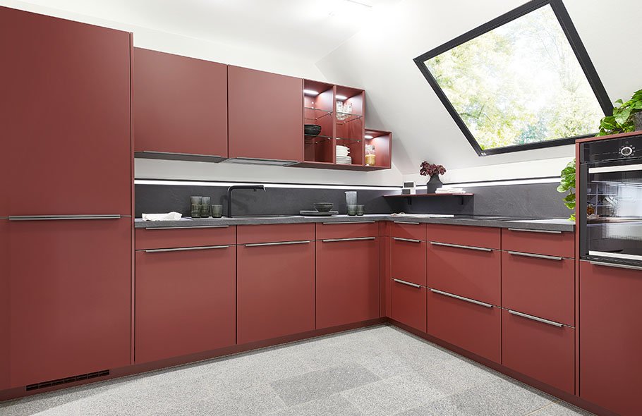 Hidden handle detail on a contemporary German kitchen showing the integrated pull profile at worktop level