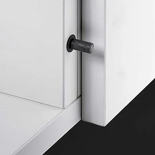 Push-to-open mechanism built into the kitchen carcass showing the internal spring and latch assembly