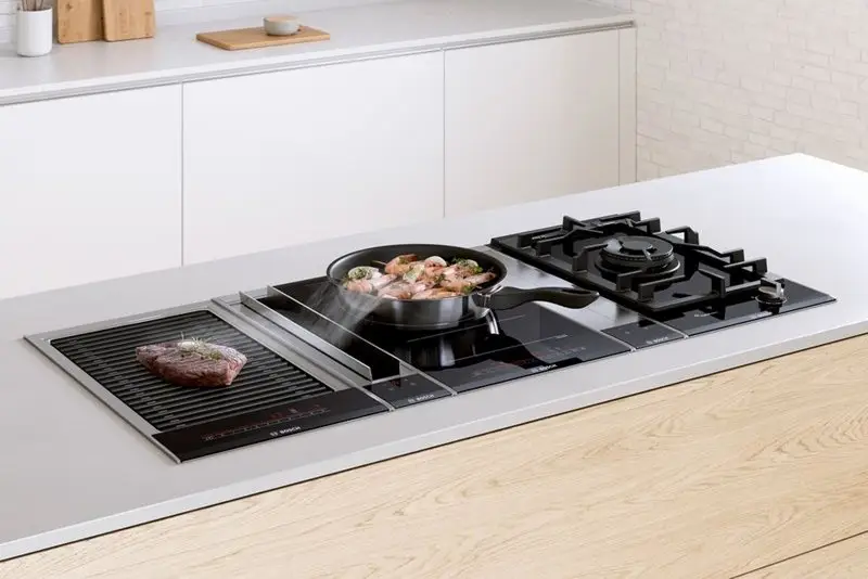 Domino hob modules showing multiple 30cm units installed side by side on a kitchen worktop in a combined cooking station