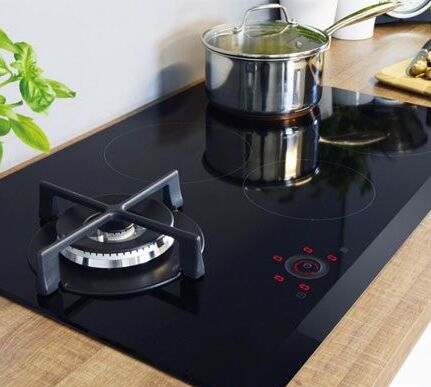 Dual fuel hybrid hob showing gas burners on one section and induction zones on the other within a single unit