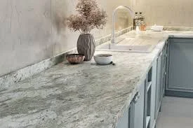 Limestone kitchen worktop on an island showing the warm cream and buff natural stone surface with the soft, fine-grained texture and honed finish characteristic of limestone in a classic kitchen design