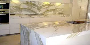 White marble kitchen worktop showing a book matched slab pattern on a large island with waterfall ends in a contemporary German kitchen design