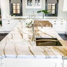 Marble kitchen worktop in a contemporary handleless kitchen showing white marble with grey veining on an island with a polished finish