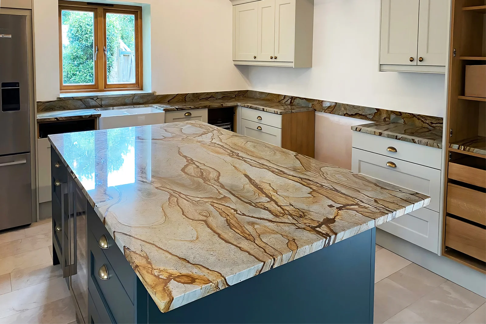 Quartzite worktop in a contemporary kitchen showing the dramatic white and grey veining characteristic of premium quartzite stone installed on an island
