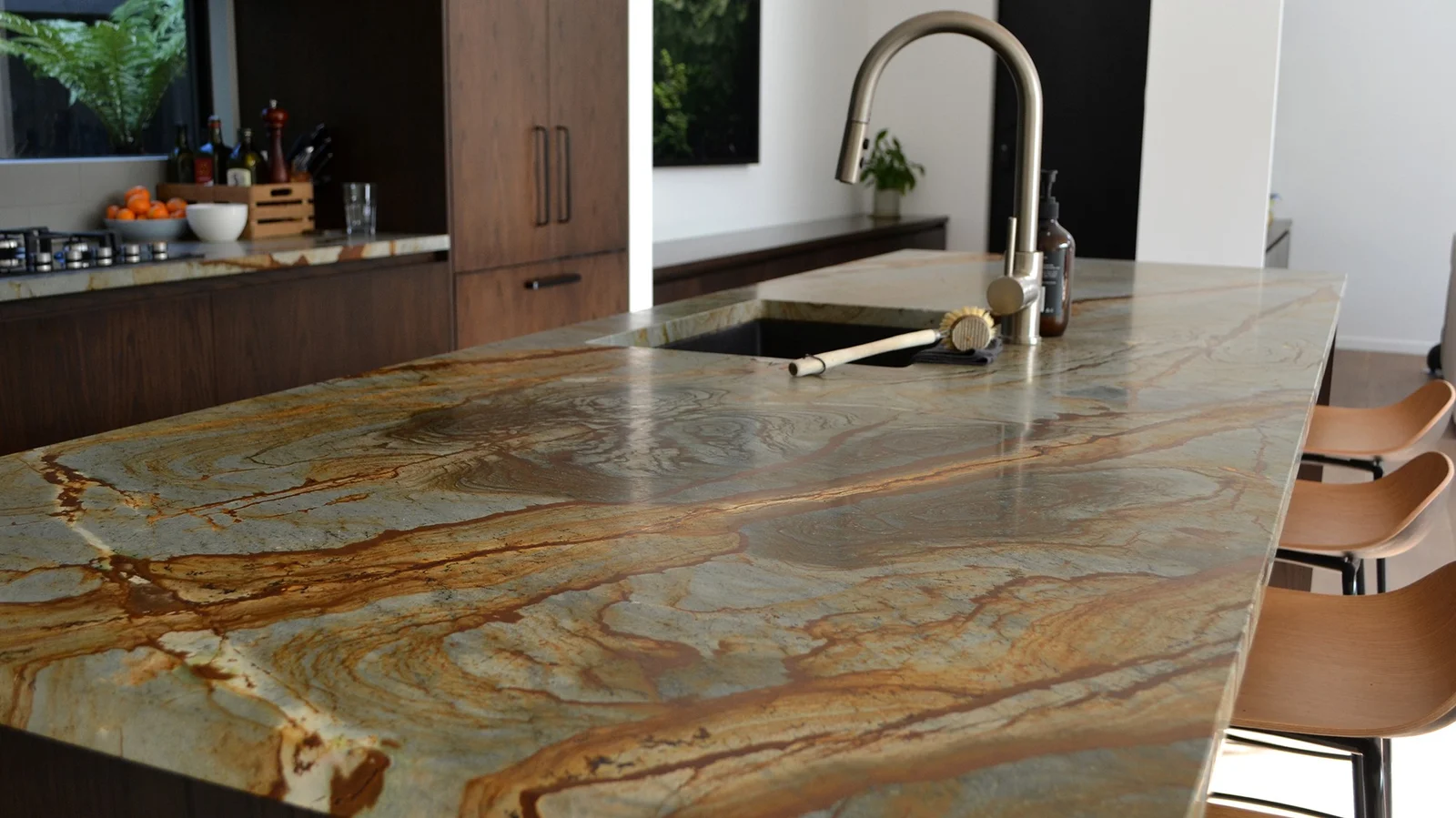Quartzite worktop close-up showing the dense crystalline surface texture and natural veining pattern with the polished finish reflecting light across the mineral structure