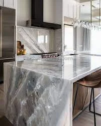 Quartzite kitchen worktop showing the full-length view of the stone surface with sweeping veins running across the island in a handleless German kitchen design