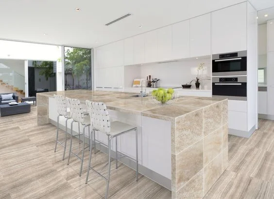 Travertine worktop in a classic kitchen showing the warm cream and beige natural stone surface with characteristic layered veining and filled voids in a honed finish