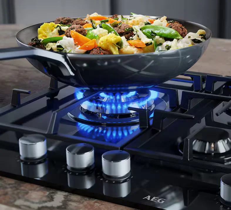 Gas hob showing cast iron pan supports and burner crowns in a stainless steel configuration
