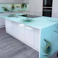 Glass kitchen worktop on an island showing how back-painted toughened glass reflects light across a contemporary kitchen and how the surface interacts with overhead lighting in a handleless German kitchen design