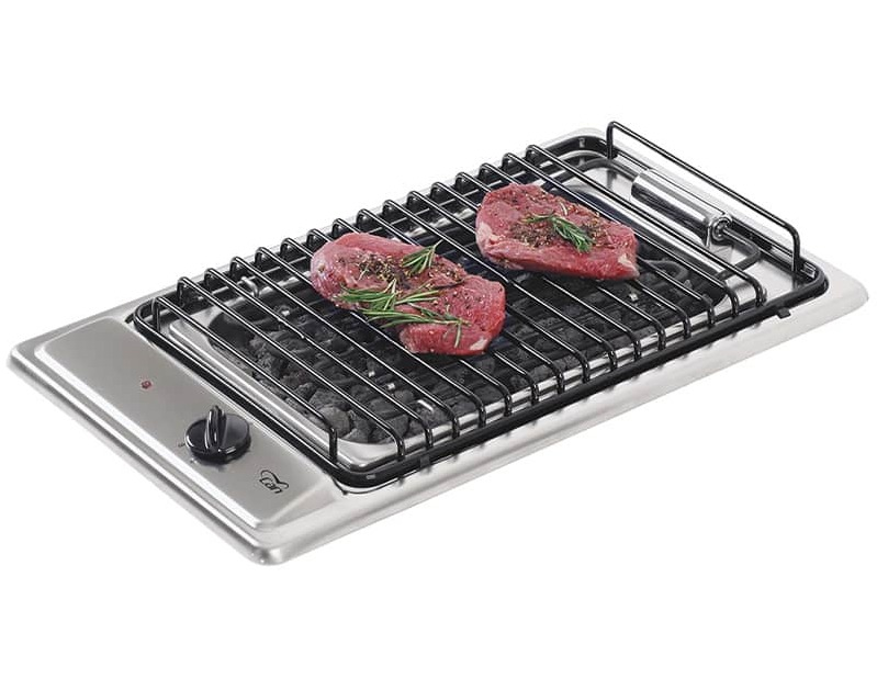 Built-in grill hob showing open cast iron grates above electric elements in a stainless steel domino module with drip tray visible below