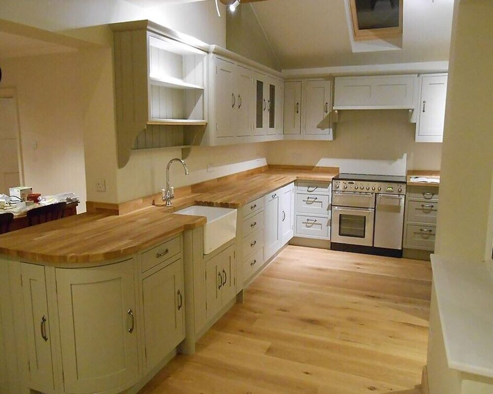 Solid wood worktop samples showing different timber species side by side including oak, walnut, and maple demonstrating the range of natural colours and grain patterns available for kitchen worktops
