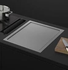 Teppanyaki hob showing large flat steel cooking plate set into the worktop for direct-surface cooking