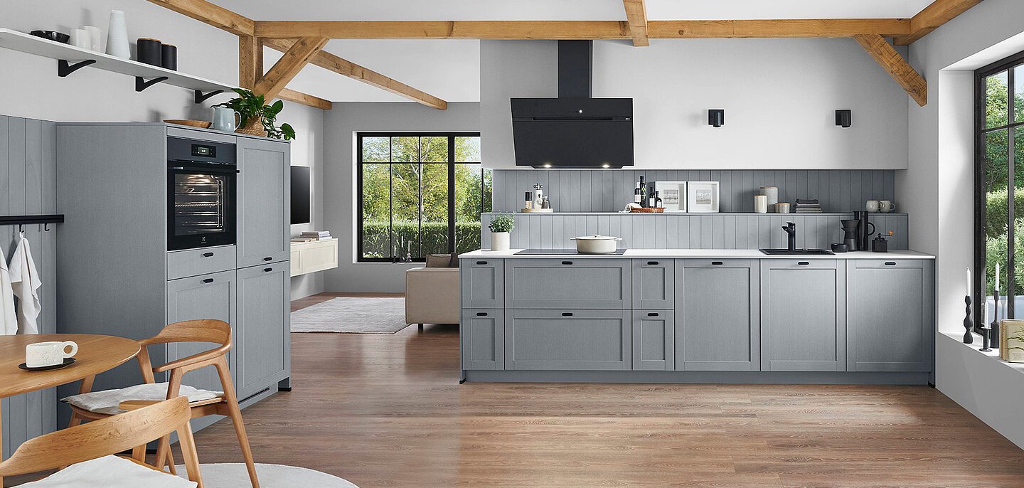 In-frame German kitchen with traditional handles showing proportioned hardware choices on framed door and drawer fronts