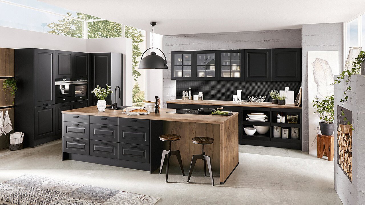 Contemporary German handled kitchen showing slim bar handles in a dark matt finish across base and wall units