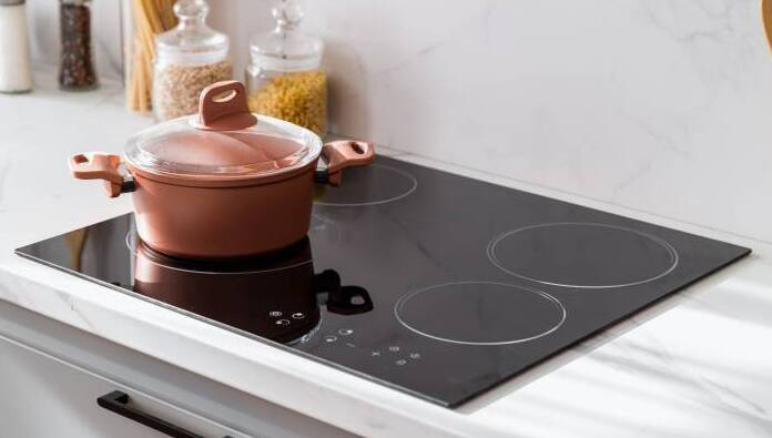 Top-mounted induction hob showing the hob sitting on the worktop surface with a bevelled edge or frame at the perimeter