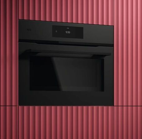 AEG compact oven in the 45cm format showing the eye-level position in an appliance tower with a clean front panel and compact door design