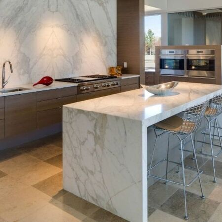Calacatta style quartz worktop on a kitchen island showing the marble-effect white background with bold grey veining and the consistent pattern across the full island surface