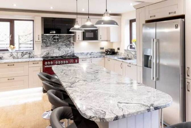 Viscount White granite worktop showing the light grey and white speckled pattern with a polished surface finish installed in a contemporary kitchen