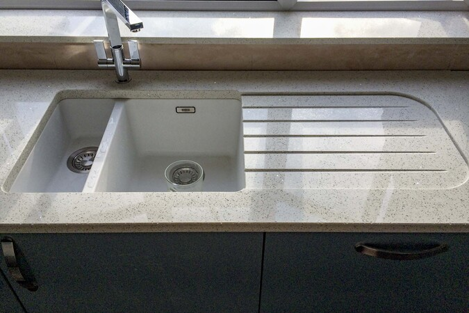 Recessed granite drainer showing the shallow lowered field with machined grooves within it, containing water more effectively than surface grooves alone