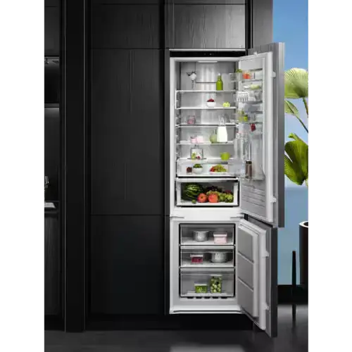 193cm high integrated fridge freezer in a tall kitchen housing unit showing the taller format of the larger integrated fridge freezer with greater internal capacity for fresh food storage in a kitchen renovation or extension
