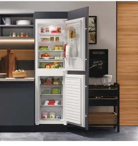 50/50 split integrated fridge freezer showing equal allocation of space between the fridge section above and freezer drawers below in a tall built-in integrated appliance behind furniture doors in a contemporary kitchen