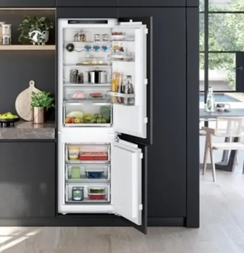 60/40 split integrated fridge freezer showing the larger fridge section with 60 percent of the space allocated to chilled storage and 40 percent to the freezer drawers at the base of the appliance in a fitted kitchen installation