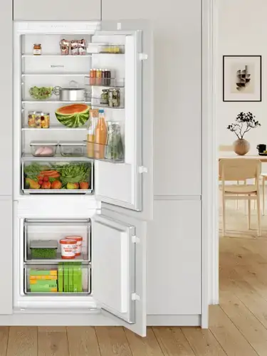 70/30 split integrated fridge freezer showing the predominantly fridge-led layout with 70 percent of internal space allocated to chilled food storage and 30 percent to the freezer section at the bottom