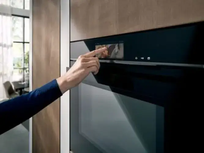 Automatic cooking programmes on a built-in oven touchscreen display showing the menu of food categories weights and settings that the oven uses to automatically set temperature function and cooking time for different food types and weights