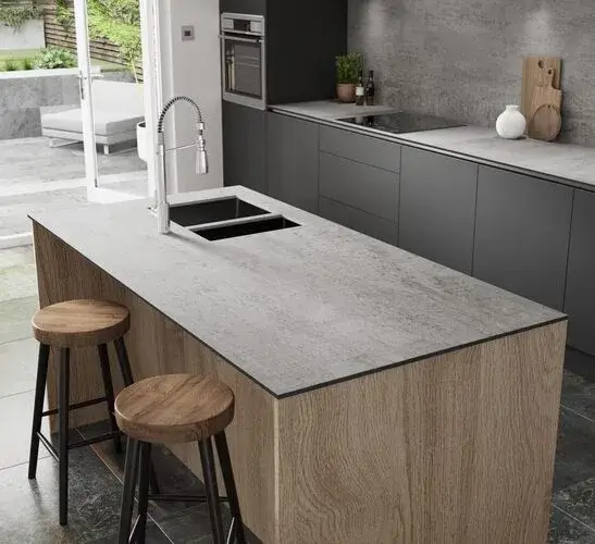 HPL worktop in a contemporary kitchen showing the realistic stone-effect surface of high-pressure laminate with the clean edge profile and consistent pattern across a kitchen worktop run in a modern German kitchen installation