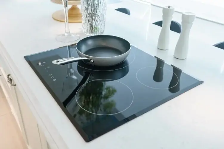 Gloss finish vented hob showing the reflective high-sheen glass surface with zone indicators and a mirror-like quality across the cooking area