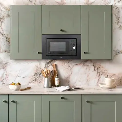Wall unit microwave showing a built-in microwave installed in a wall cabinet above the kitchen worktop demonstrating the shallow depth requirement for wall unit microwave installation with the appliance fitted within the standard wall unit depth of 300 to 350mm including rear ventilation clearance